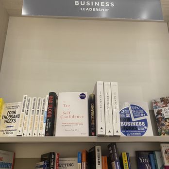 Indigo - A bookshelf contains books related to business and leadership, including titles on self-confidence, management, and entrepreneurship, with a 'Business Leadership' sign above. - Bookstores Near Me - Oshawa, Ontario