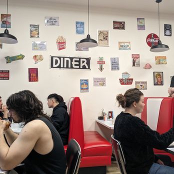 Donut Villa Diner - Interior of left seating area with all the bad signs they should take down and paint a retro swoop instead - Donuts Near Me - Cambridge, Massachusetts