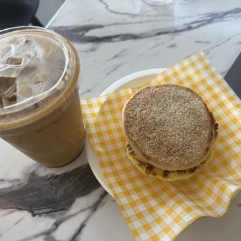 Cure Bakery & Coffee - Breakfast Sandwich with Bacon and iced Carmel Latte - Bakeries Near Me - Austin, Texas