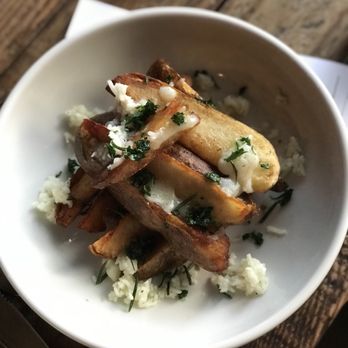Curio - Fries with house made truffle oil and a deliciously soft cheese - a must buy and table favorite! - Bars Near Me - San Francisco, California