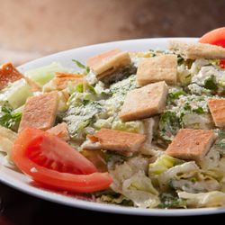 Little Greek Fresh Grill - Windermere - Caesar Salad - Fresh romaine lettuce, topped with Caesar dressing, tomatoes, parmesan, cheese and croutons.
