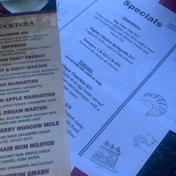 Briggs Corner Pizzeria - special menu and cocktails - Two menus from Briggs Corner Pizzeria in Attleboro, MA, are shown on a table, featuring drink and food options with illustrations. - Pizza Near Me - Attleboro, Massachusetts