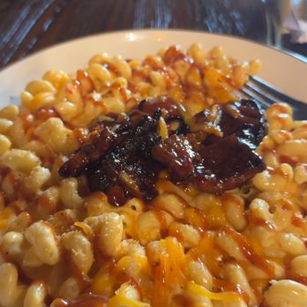 Nic & Norman's - Brisket topped Mac n cheese  drizzled with bbq is truly irresistible and my favorite I've ever had! - Southern Near Me - Greenville, South Carolina