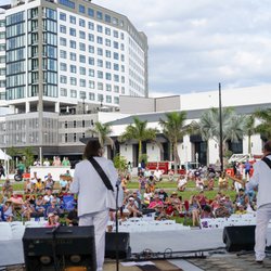 Day show at Caloosa Sound Amphitheater with Luminary Hotel and Caloosa Convention Center in the background
