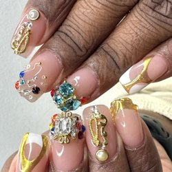 Overlay, acrylic on natural nails with 3D charms and rhinestones. Chrome and French done in gel