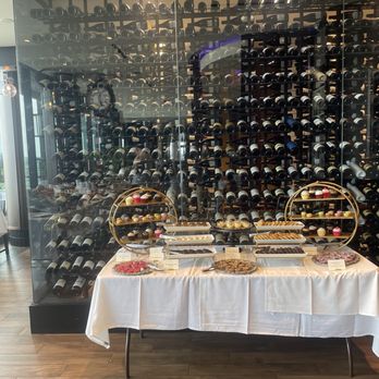The Bygone - Foyer with dessert table and wine wall. - American Near Me - Baltimore, Maryland