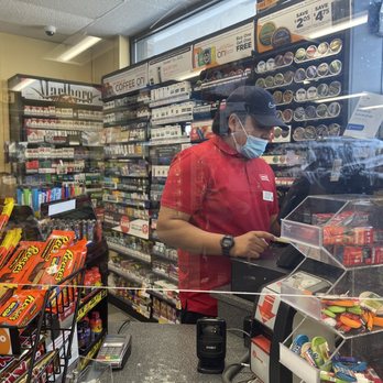 Circle K - a man wearing a face mask in a grocery store - Gas Stations Near Me - Lake Forest, California