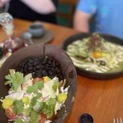 El Barrio - Chilaquiles with an egg (front) and enchiladas suizas (back)