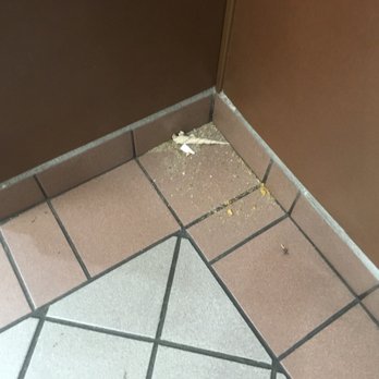 A&W - a bathroom floor with a broken toilet paper dispenser - Fast Food Near Me - Kelowna, British Columbia