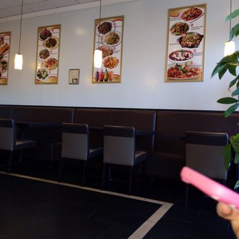 Red Chilli - a woman holding a pink object in a restaurant - Chinese Near Me - Redlands, California