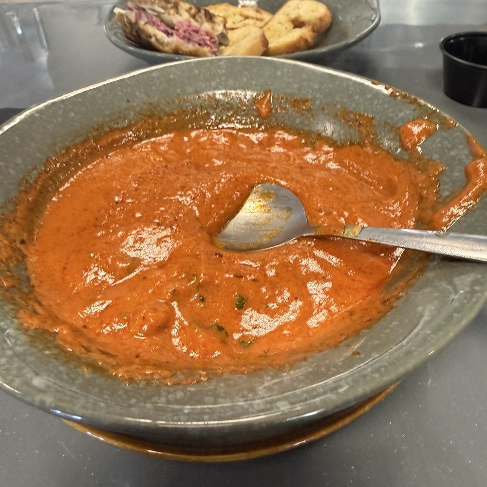 Village Pub - Roasted red pepper tomato soup with the reuben sandwich in the background. - Pubs Near Me - Snowshoe, West Virginia Village Pub - Roasted red pepper tomato soup with the reuben sandwich in the background. - Pubs Near Me - Snowshoe, West Virginia