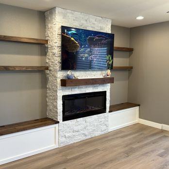 Rustique by J&P - Built-in: Stone, walnut mantle & walnut floating shelves, storage benches (walnut lids with breadboard ends). - Carpenters Near Me