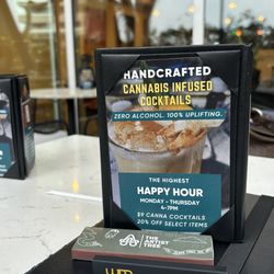 The Artist Tree Dispensary - Advertisement out on the lounge patio table.