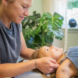 Climb Chiropractic - Dr. Chelsea adjusting a four-year-old, and incorporating CFT fascial/soft tissue work to help release restricted jaw growth.