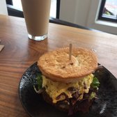 Photo of Streamline - San Francisco, CA, United States. Breakfast sandwich with bacon and avocado, Iced latte