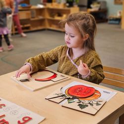 Southwest Montessori Academy - A student working with a puzzle