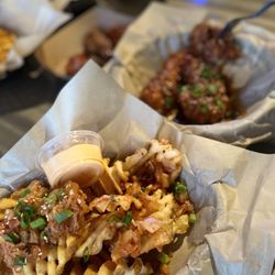 Chi-Kin - Kimchi waffle fries, chicken tenders in background