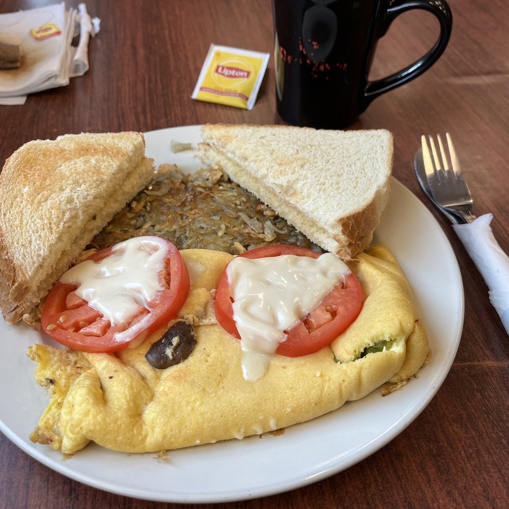 Red River Bistro - Veggie omelette, hash browns and sourdough toast; with Lipton posing as tea. - Pizza Near Me - Baker, Montana Red River Bistro - Veggie omelette, hash browns and sourdough toast; with Lipton posing as tea. - Pizza Near Me - Baker, Montana