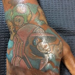 Clover City Ink - Mario on hand tattoo