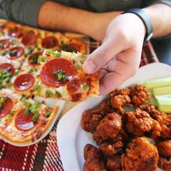 Ledo Pizza - a person taking a slice of pizza - Italian Near Me - Lanham, Maryland Ledo Pizza - a person taking a slice of pizza - Italian Near Me - Lanham, Maryland