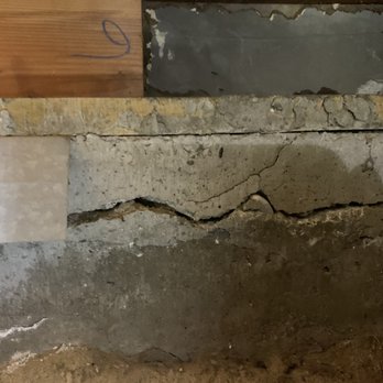 ClayCon Developers - Old foundation - A concrete foundation shows significant cracking and damage, with uneven surfaces and exposed aggregate, indicating structural issues. - Foundation Repair Near Me