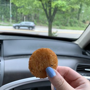 Bojangles - a person holding a donut in their hand - Fast Food Near Me - Knoxville, Tennessee