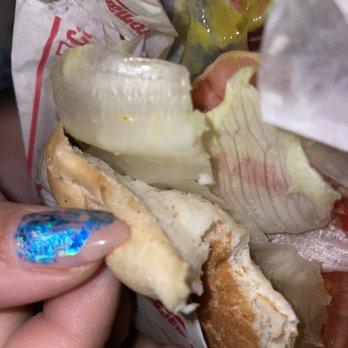Dilallo - a person holding a hot dog in a wrapper - Fast Food Near Me - Montreal, Quebec Dilallo - a person holding a hot dog in a wrapper - Fast Food Near Me - Montreal, Quebec