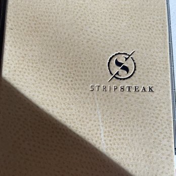 Stripsteak - Cover of the menu at Stripsteak on the Grand Lanai Terrace of the International Market Place in Waikiki, Honolulu, Hawaii. - Steakhouses Near Me - Honolulu, Hawaii