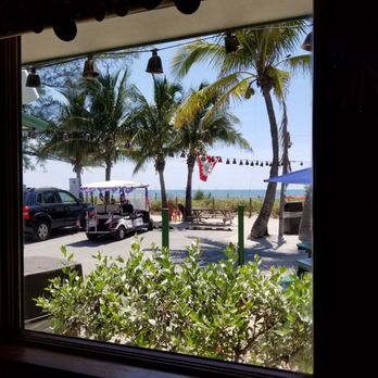 The Mucky Duck - The view outdoors with corn hole games - Seafood Near Me - Captiva, Florida The Mucky Duck - The view outdoors with corn hole games - Seafood Near Me - Captiva, Florida
