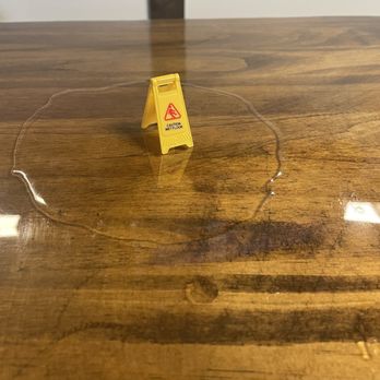 Four Circles Brewery - a caution sign on a table - Breweries Near Me - Brighton, Michigan