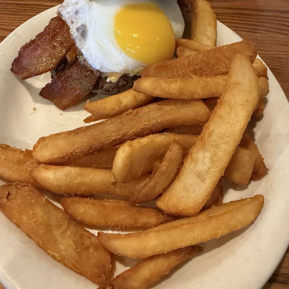 Breakfast burger with egg, bacon and french fries