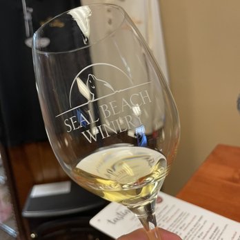 Seal Beach Winery - a hand holding a wine glass - Wineries Near Me - Los Alamitos, California Seal Beach Winery - a hand holding a wine glass - Wineries Near Me - Los Alamitos, California