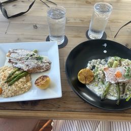 Reddish over risotto (left) and salmon served under a smoked dome at the table. Reddish over risotto (left) and salmon served under a smoked dome at the table.