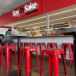 a row of red stools in a restaurant