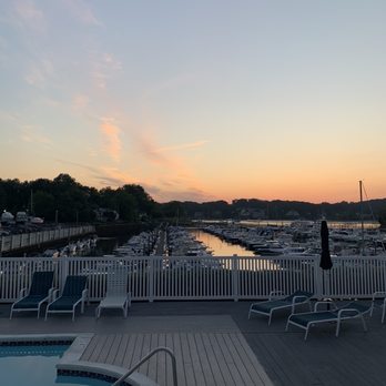 Whales Tale - a woman standing on a deck overlooking a marina - Seafood Near Me - Northport, New York Whales Tale - a woman standing on a deck overlooking a marina - Seafood Near Me - Northport, New York
