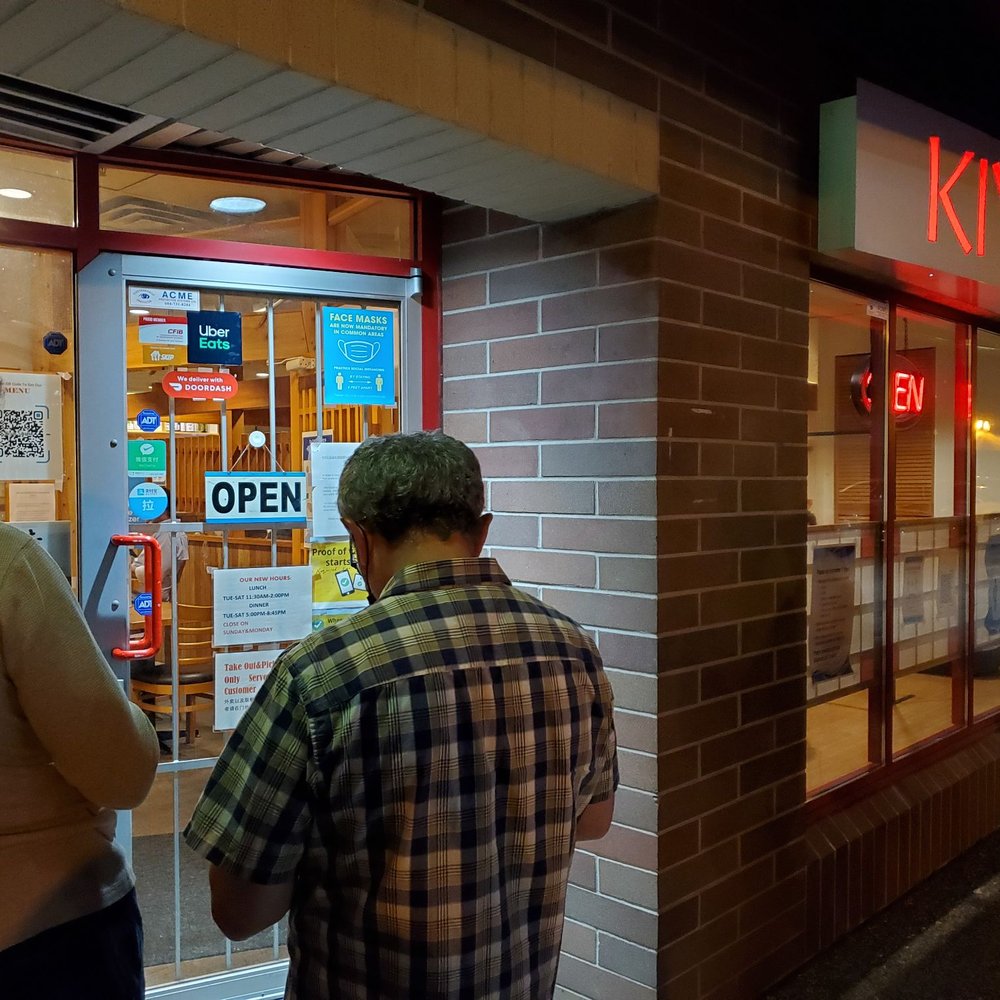 two men standing outside a kiyo sushi two men standing outside a kiyo sushi