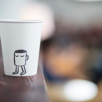 Stand Coffee at  Brooklyn Flea -  paper cup with a sticker on it - Coffee & Tea Near Me - Brooklyn, New York
