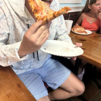 South Beach Pizzeria - Mike eating his slice - Pizza Near Me - Vero Beach, Florida