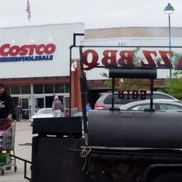 a man pushing a cart full of food a man pushing a cart full of food