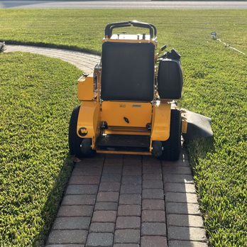 Aaron's Lawn Care - a lawn mower on a driveway - Lawn Services Near Me Aaron's Lawn Care - a lawn mower on a driveway - Lawn Services Near Me