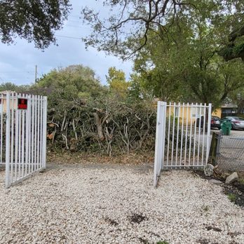 Javier Landscaping - a man standing in front of a gate - Landscaping Near Me