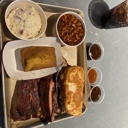 Potato salad, baked beans, corn bread, Texas toast, brisket, and ribs. So MUCH FOOD!! Potato salad, baked beans, corn bread, Texas toast, brisket, and ribs. So MUCH FOOD!!