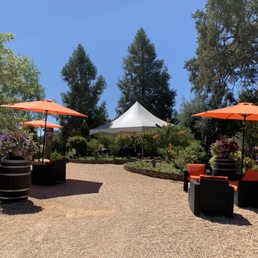 a patio area with tables and umbrellas a patio area with tables and umbrellas