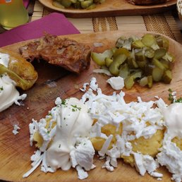 Sarmale with polenta (boiled cornmeal), cheese, pickles and sausage.