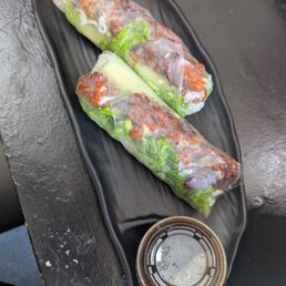 Pork spring rolls with a pre packaged sauce. Pork spring rolls with a pre packaged sauce.