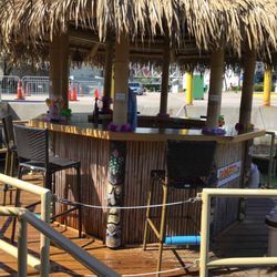 Cruisin' Tikis Miami - Circular raft bar with 6 stools around the outside - captain's wheel inside the bar