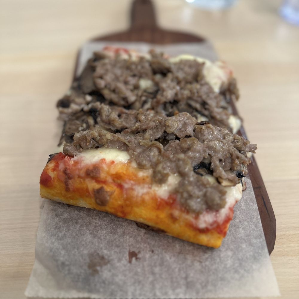 RomanSQ - a slice of pizza on a cutting board - Pizza Near Me - Sarasota, Florida RomanSQ - a slice of pizza on a cutting board - Pizza Near Me - Sarasota, Florida