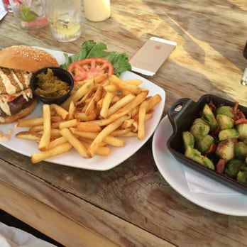 The Row - Burger with fried green tomato and some chow chow. A side of Brussels and bacon. - Southern Near Me - Nashville, Tennessee The Row - Burger with fried green tomato and some chow chow. A side of Brussels and bacon. - Southern Near Me - Nashville, Tennessee