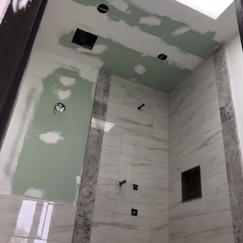 Murdock Enterprise - a shower with a skylight - General Contractors Near Me
