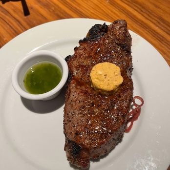 STK Steakhouse - NY Strip 14 oz topped with wagyu umami butter, side of chimichurri sauce - Steakhouses Near Me - Orlando, Florida STK Steakhouse - NY Strip 14 oz topped with wagyu umami butter, side of chimichurri sauce - Steakhouses Near Me - Orlando, Florida